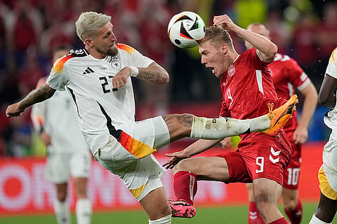 Rasmus Hojlund is challenged by Robert Andrich